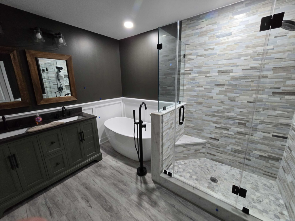 Spa-style bathroom with freestanding tub and glass walk-in shower by Dynamic Remodeling