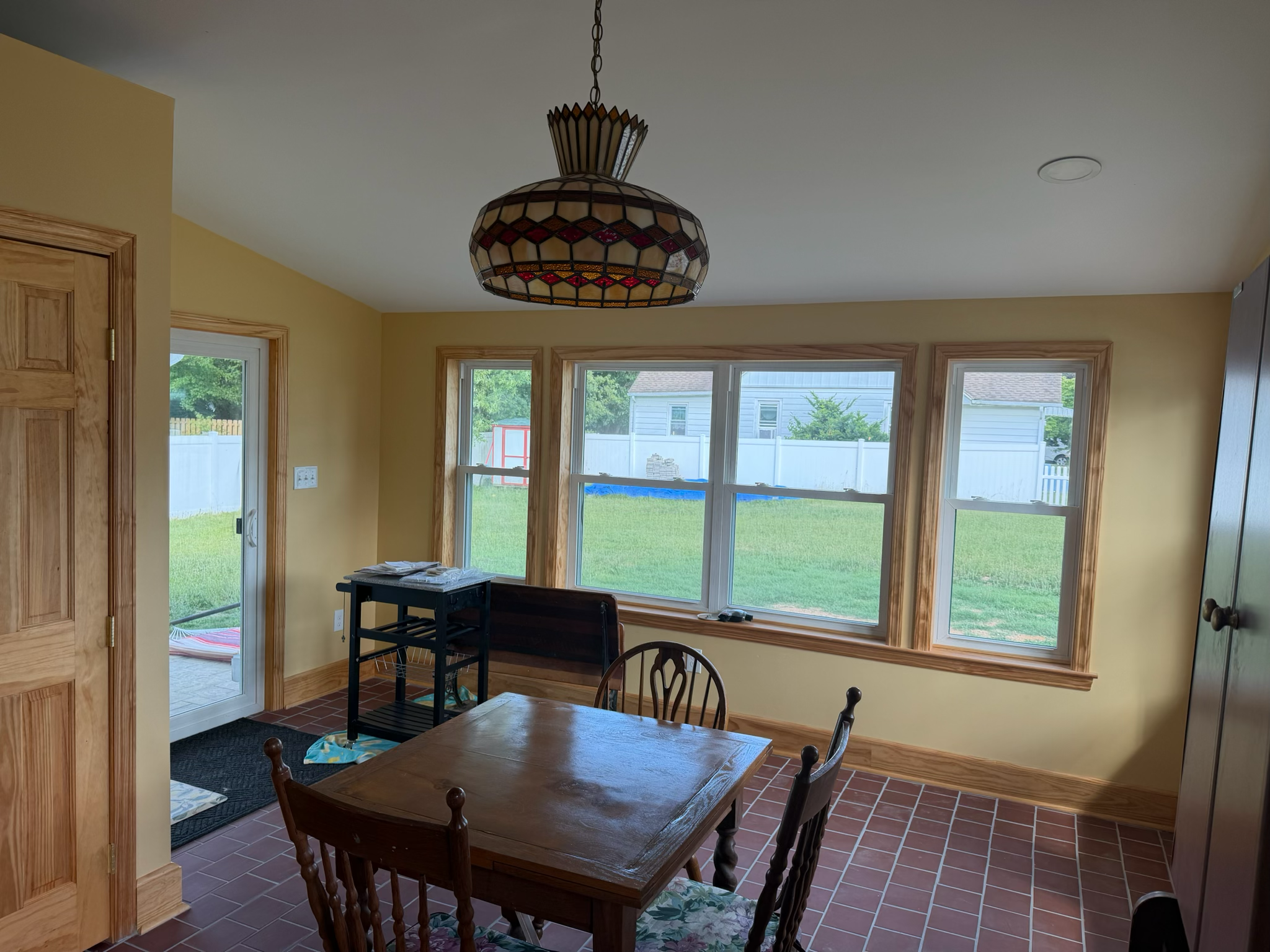 Sunroom dining addition with panoramic windows by Dynamic Remodeling
